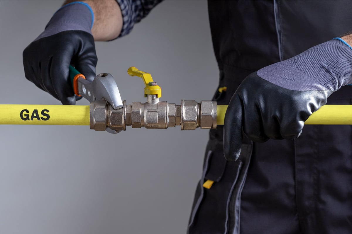 Technician repairing gas pipeline in the house